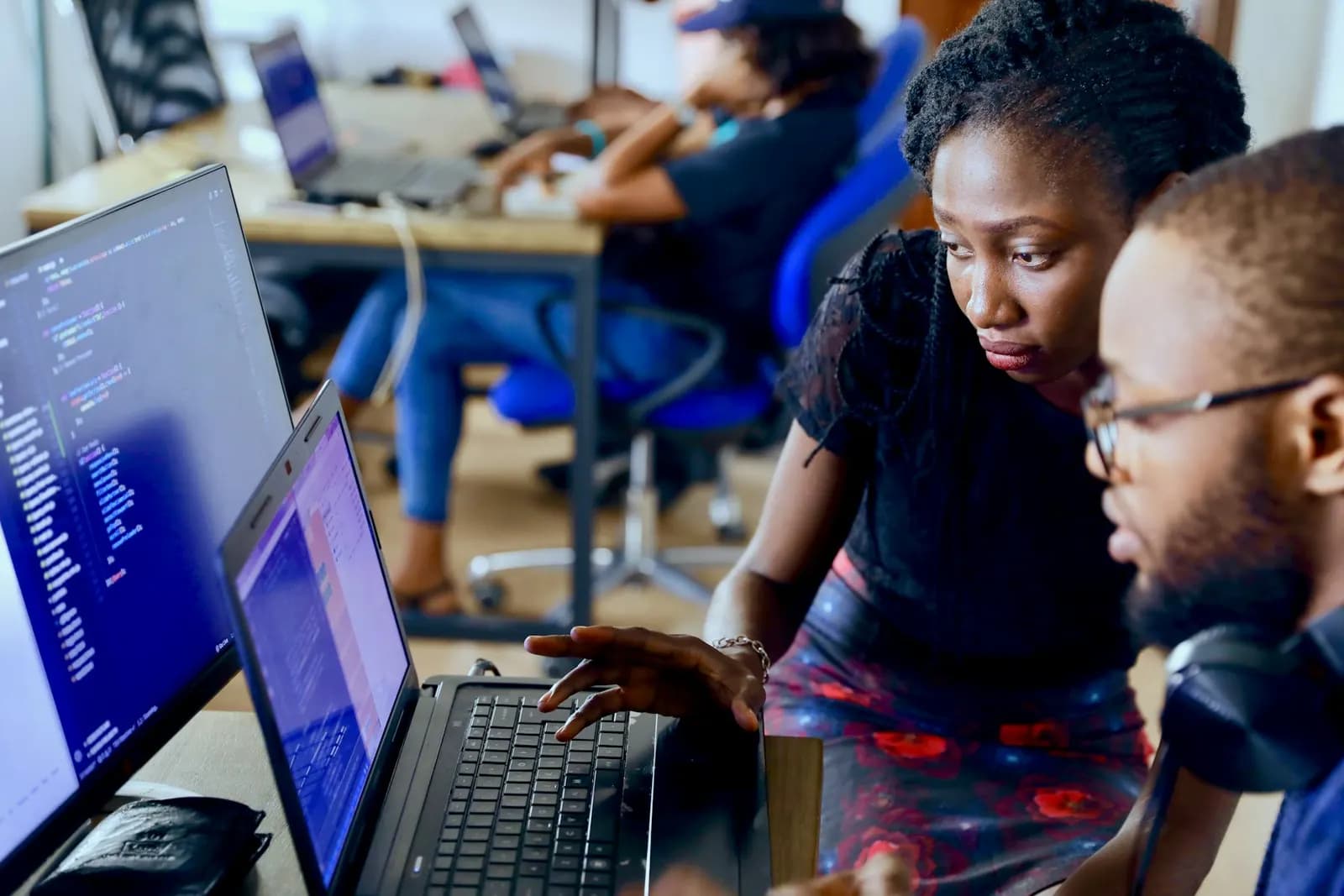 Developers reviewing code together at a desk